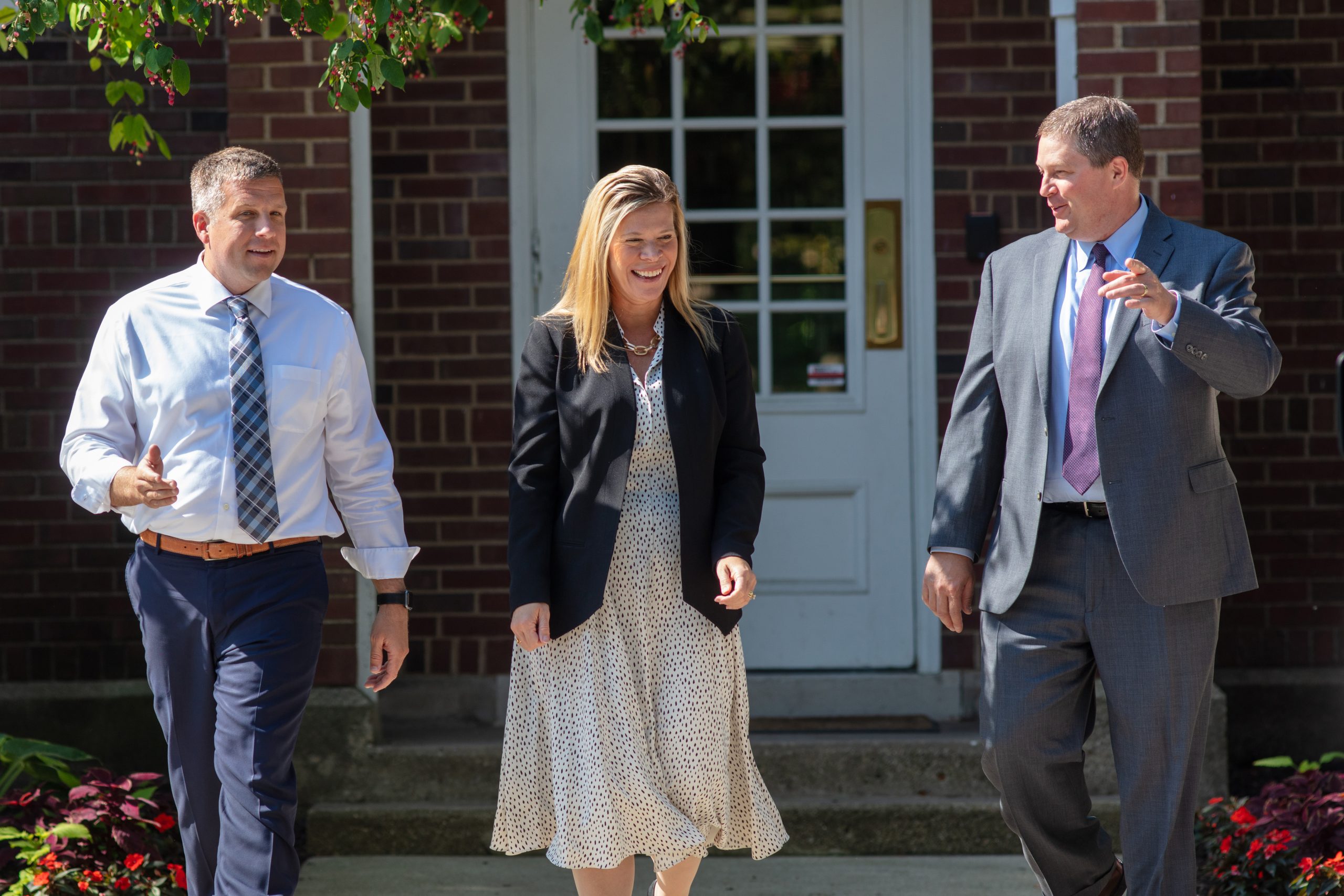 Financial advisors in meeting reviewing documents at conference table.